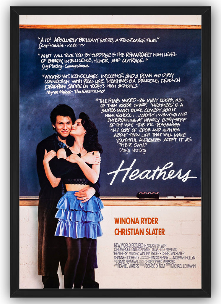 Heathers framed wall art print shows Winona Ryder kissing Christian Slater, with chalkboard reviews and orange cast names.