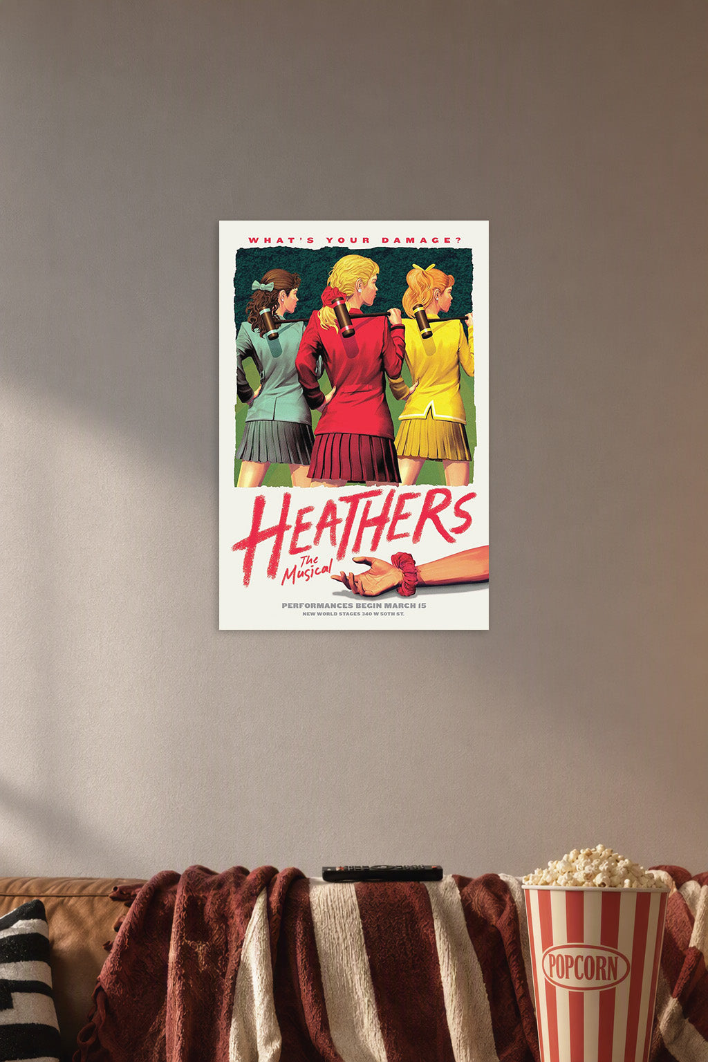 Heathers The Musical in a cozy movie room above a brown sofa with popcorn.
