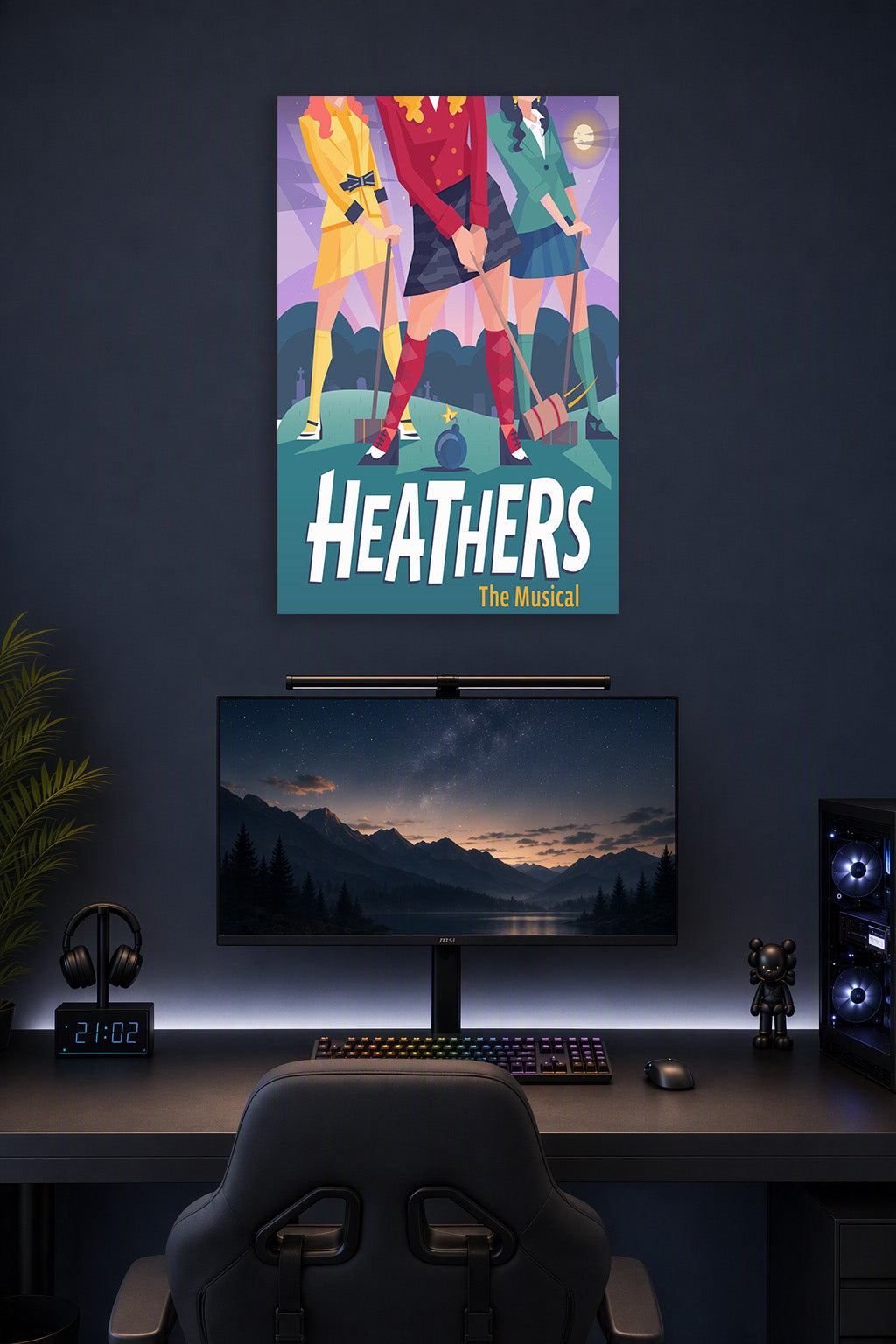 Heathers The Musical in a gaming desk setup above a monitor.