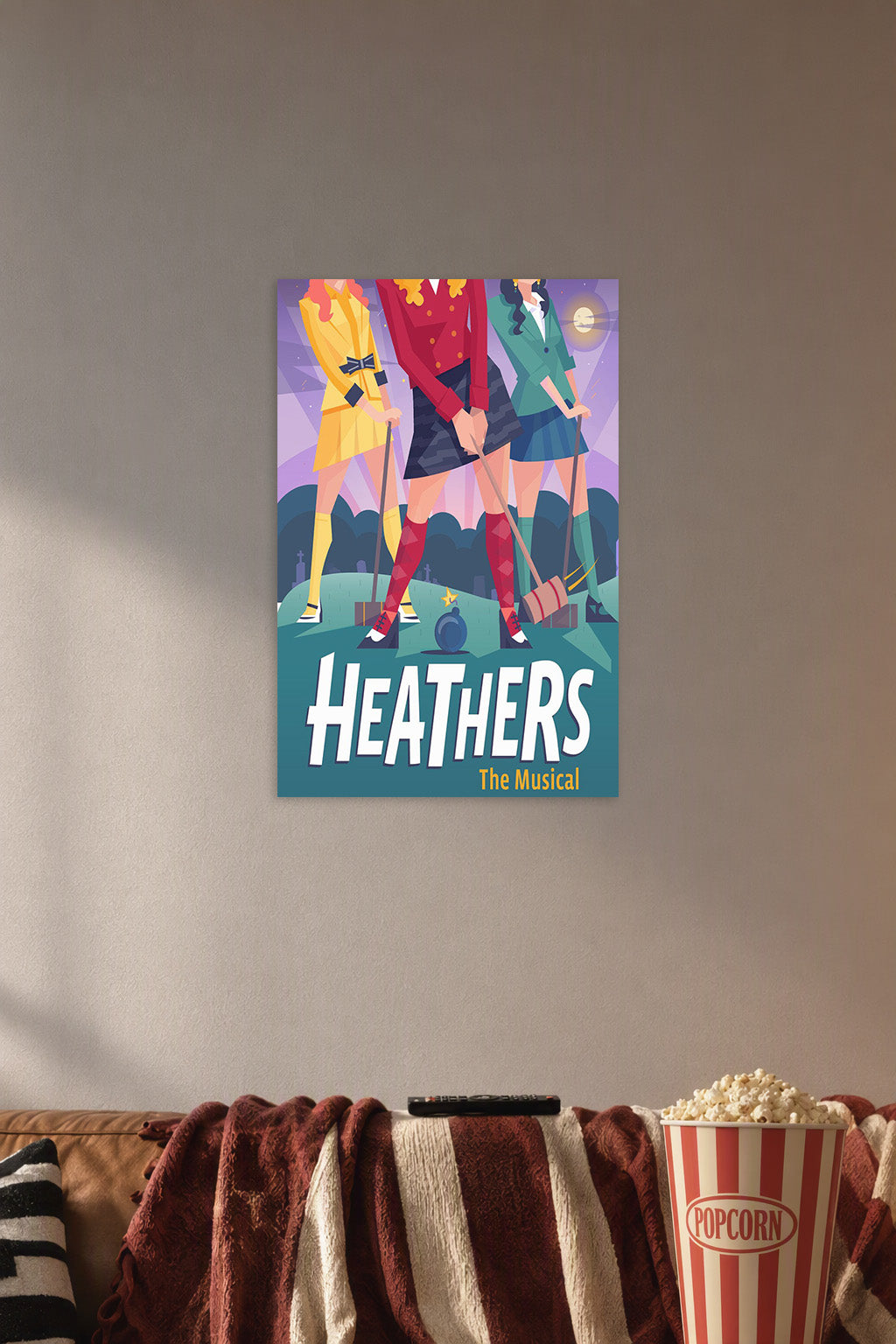 Heathers The Musical in a cozy movie room above a brown sofa with popcorn.
