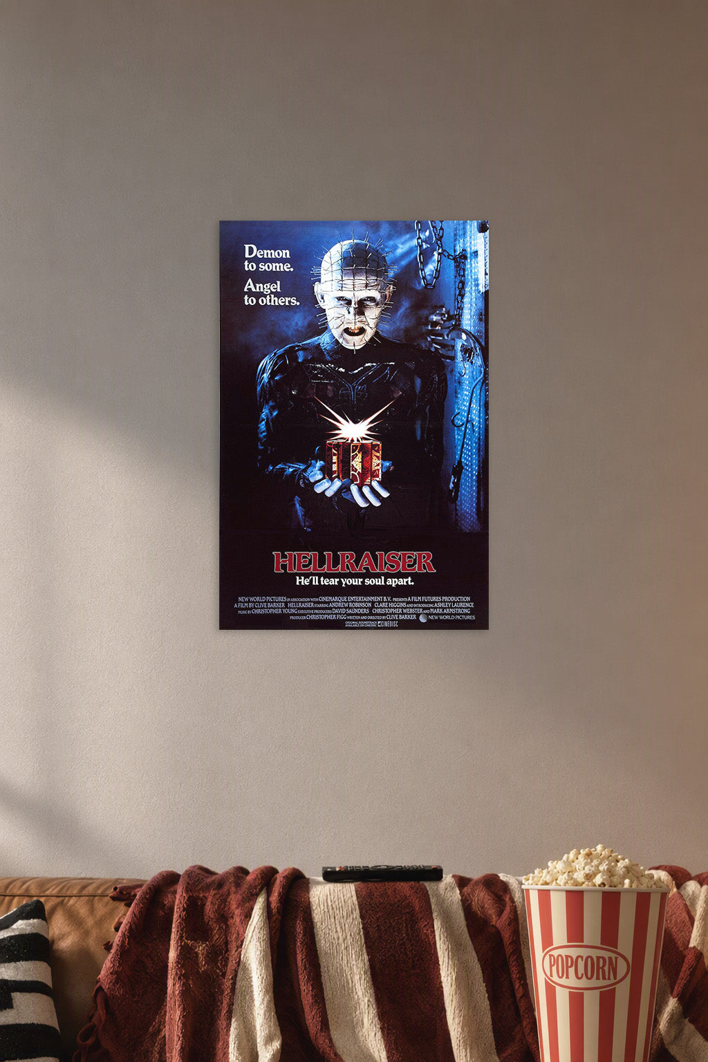 Hellraiser Pinhead in a cozy movie room above a brown sofa with popcorn.