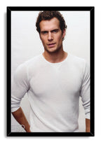 Henry Cavill framed wall art print displays a studio portrait in a white textured shirt, set within a sleek black frame.