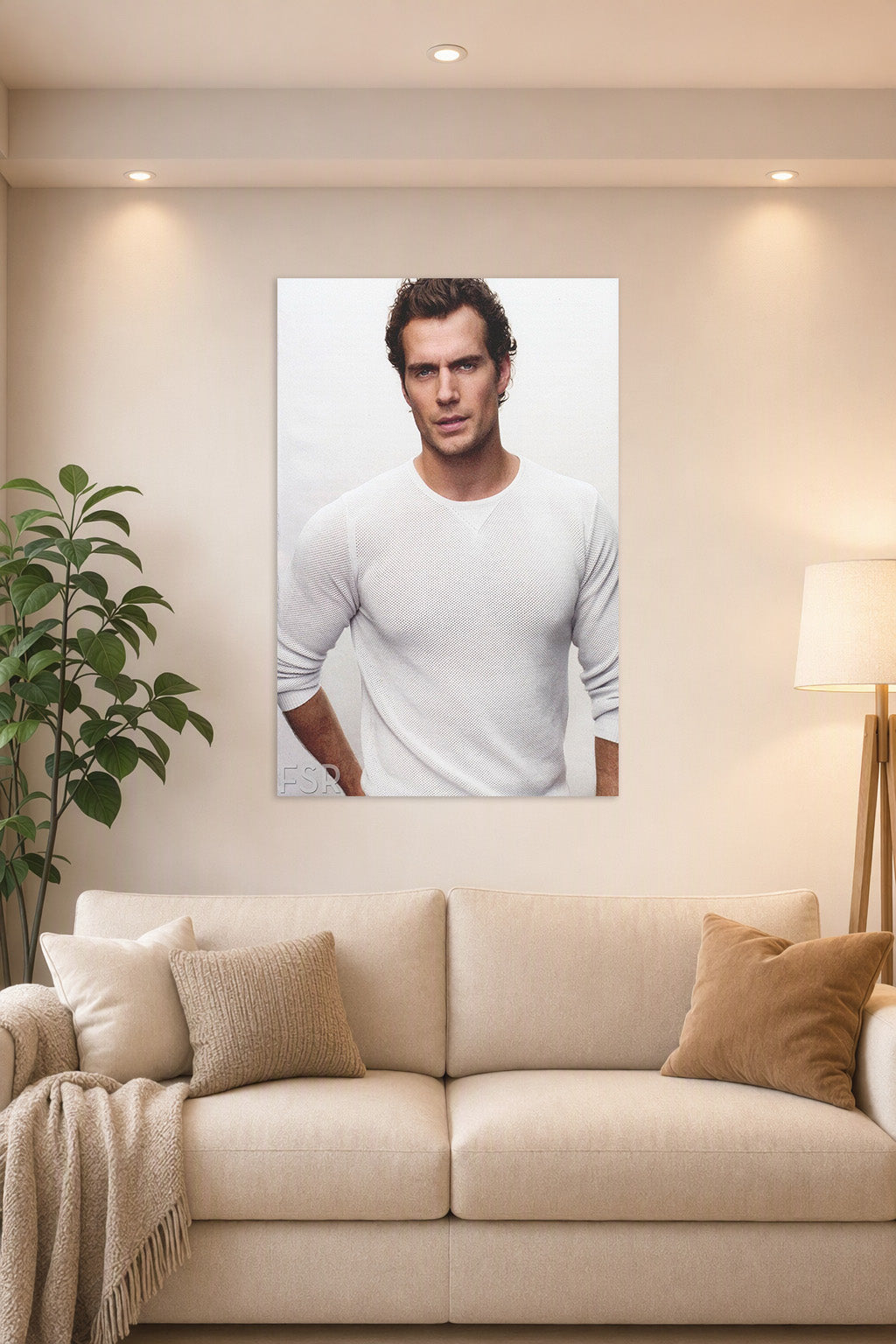 Henry Cavill in a bright living room above a beige sofa.