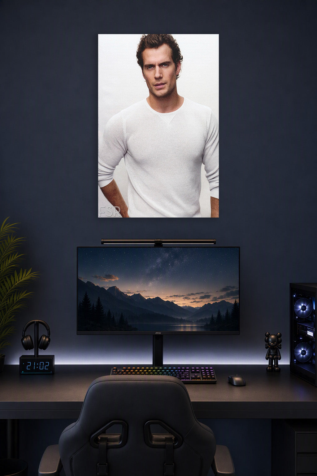 Henry Cavill in a gaming desk setup above a monitor.