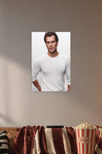 Henry Cavill in a cozy movie room above a brown sofa with popcorn.