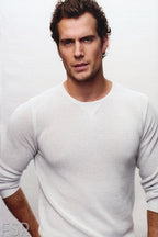 Henry Cavill poster features a waist-up studio portrait of the actor in a textured white long-sleeve shirt against pale gray.