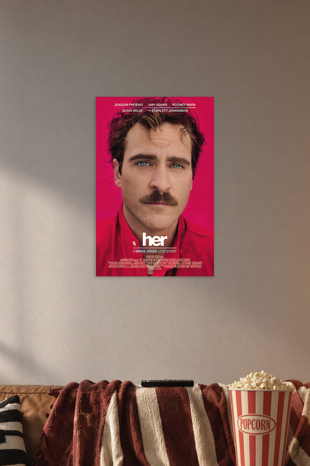 Her Movie Joaquin Phoenix in a cozy movie room above a brown sofa with popcorn.
