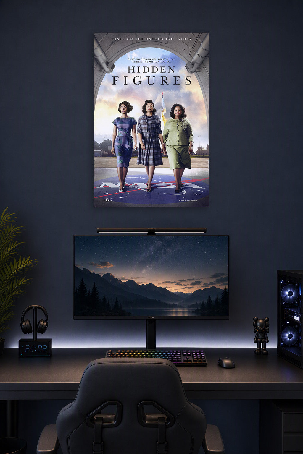 Hidden Figures Movie Poster in a gaming desk setup above a monitor.