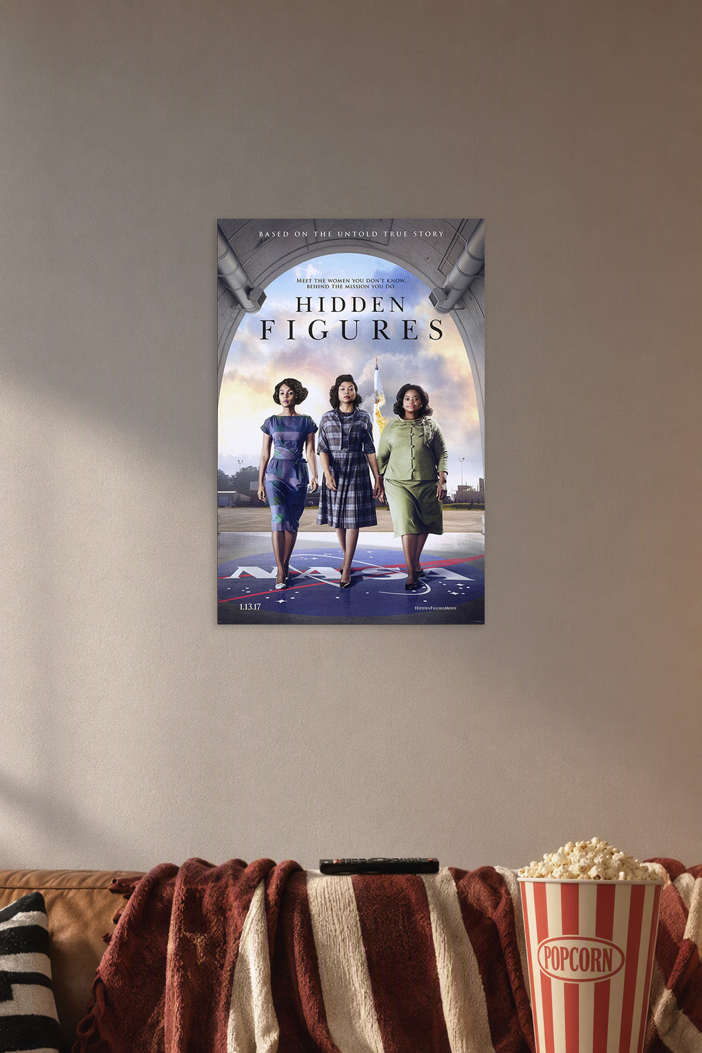 Hidden Figures Movie Poster in a cozy movie room above a brown sofa with popcorn.