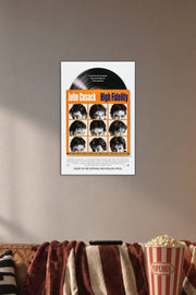 High Fidelity John Cusack in a cozy movie room above a brown sofa with popcorn.