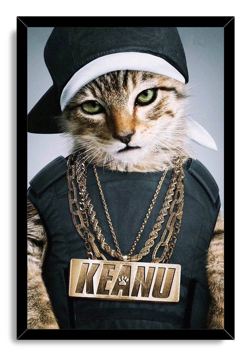 Framed hip-hop cat wall art print portrays a green-eyed tabby wearing a sideways cap, dark outfit, and large KEANU necklace.