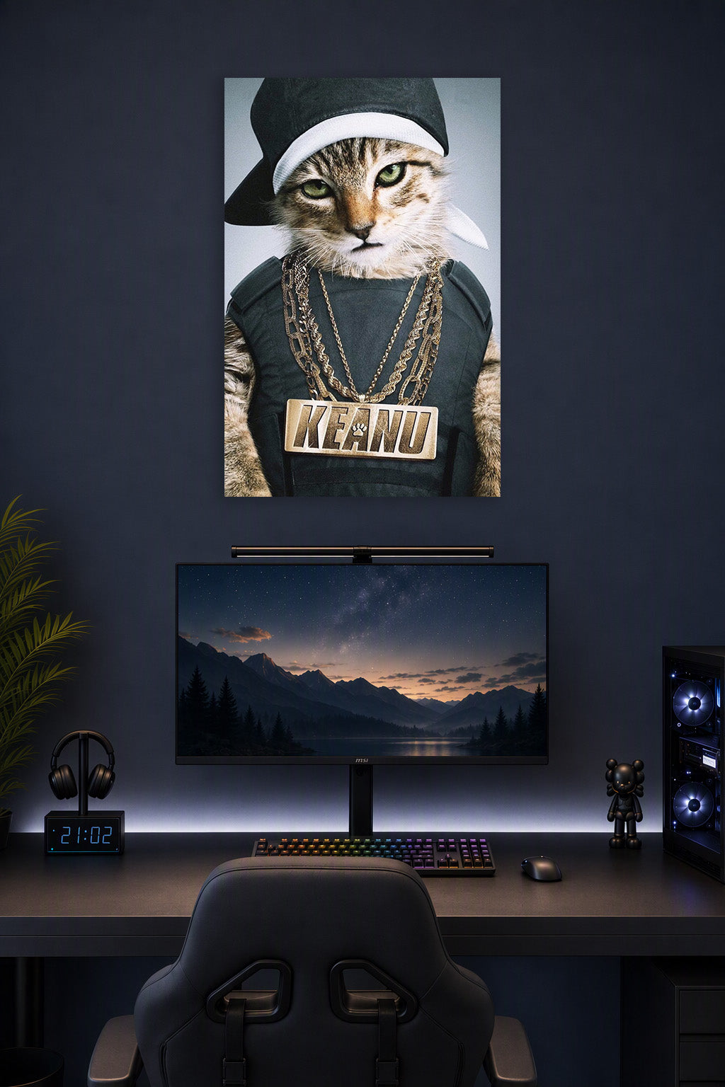 Hip-Hop Cat Keanu in a gaming desk setup above a monitor.