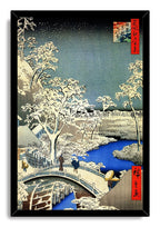Framed wall art print depicting a snowy Japanese landscape with white trees, a vivid blue river, bridge walkers, and red calligraphy panels.