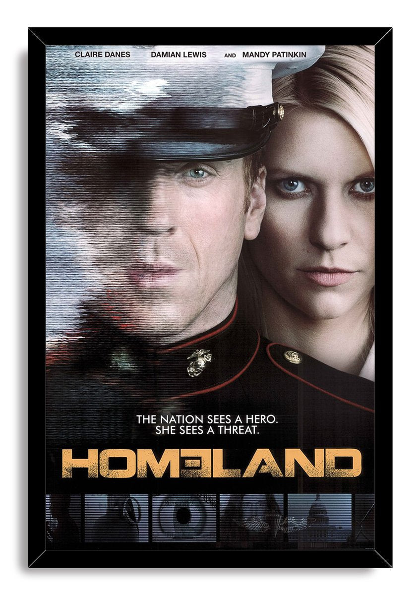 Homeland wall art print in a black frame features a uniformed man and blonde woman, with glitch-like lines and gold title lettering.