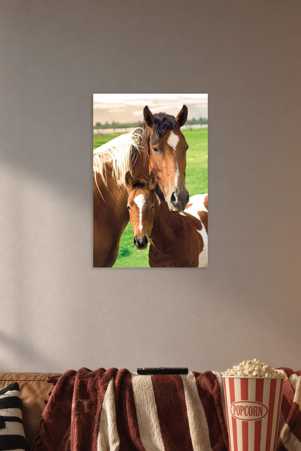 Horses and Foal in a cozy movie room above a brown sofa with popcorn.