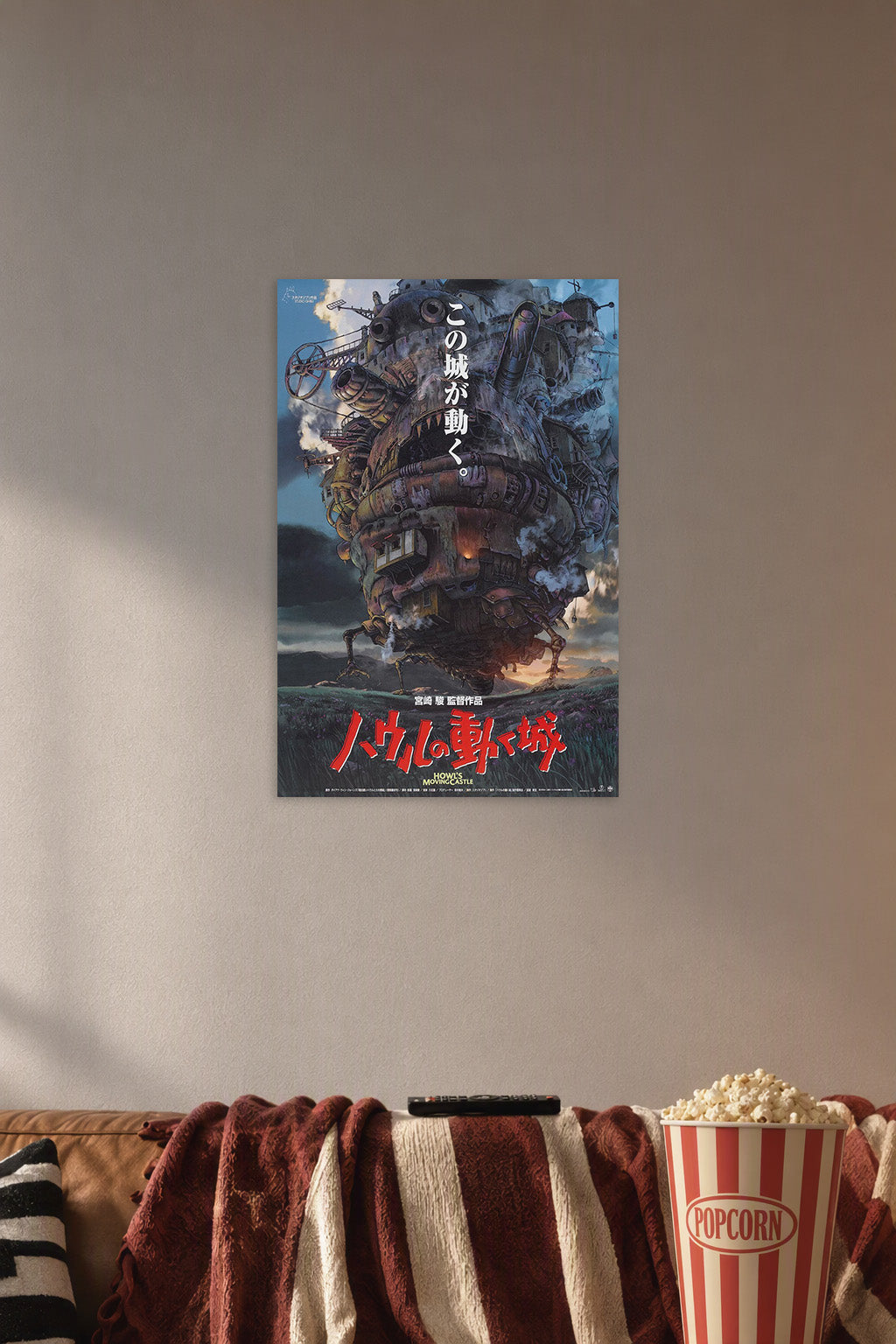 Howl's Moving Castle in a cozy movie room above a brown sofa with popcorn.