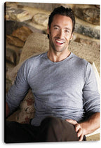 Hugh Jackman canvas wall art print featuring a relaxed smiling portrait in a gray shirt, displayed with visible wrapped edges.