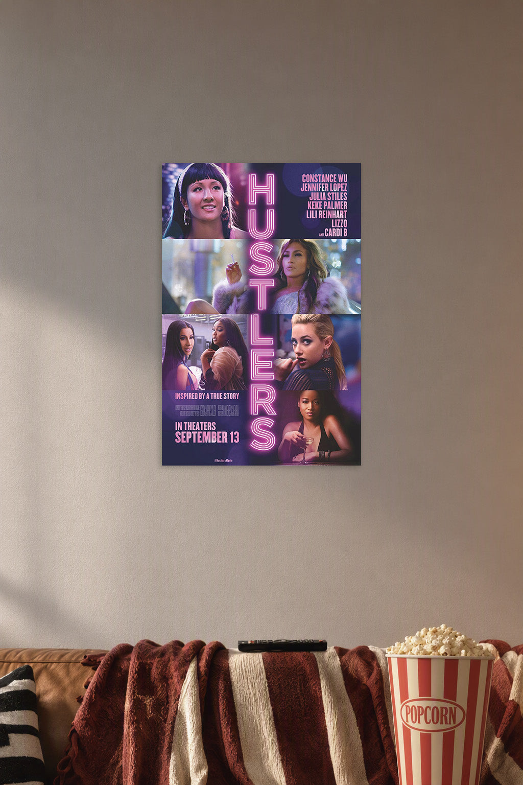 Hustlers Movie Cast in a cozy movie room above a brown sofa with popcorn.