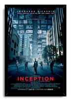 Inception framed wall art print features five figures in a city street beneath a surreal upside-down skyline in blue tones.