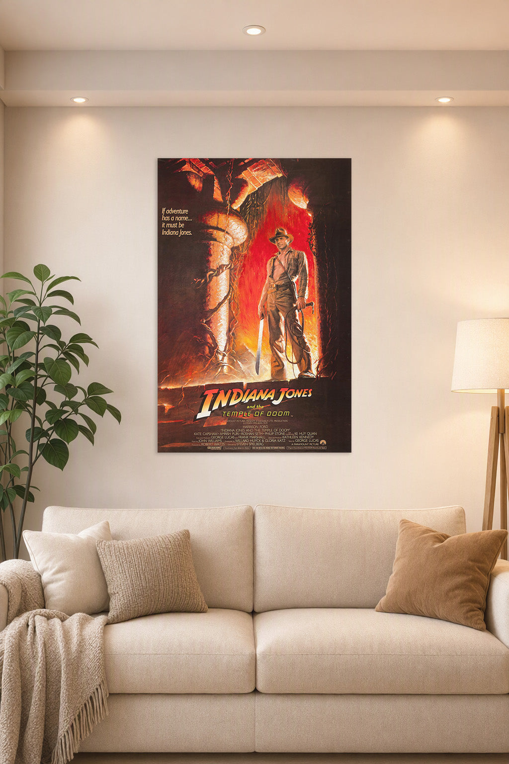 Indiana Jones and the Temple of Doom in a bright living room above a beige sofa.