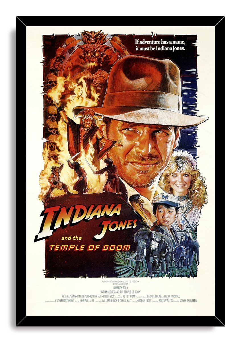 Indiana Jones and the Temple of Doom framed wall art print presents Indiana, flames, skulls, companions, and elephants in a black frame.