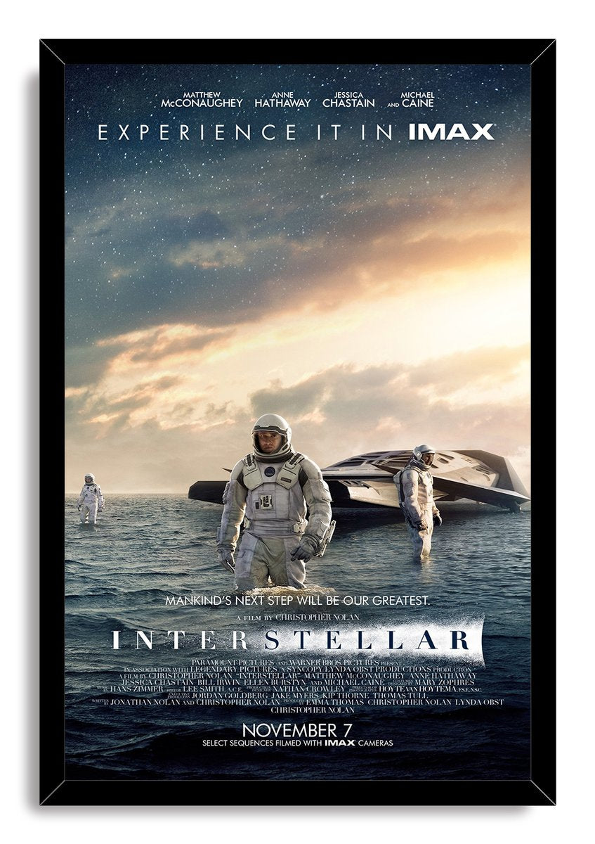 Interstellar movie poster framed wall art print with black border, astronauts standing in ocean water, spacecraft, and a luminous sky.