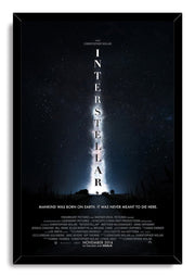 Interstellar framed wall art print displays a starry blue-black sky, bright central nebula, vertical title, and figures on a road.