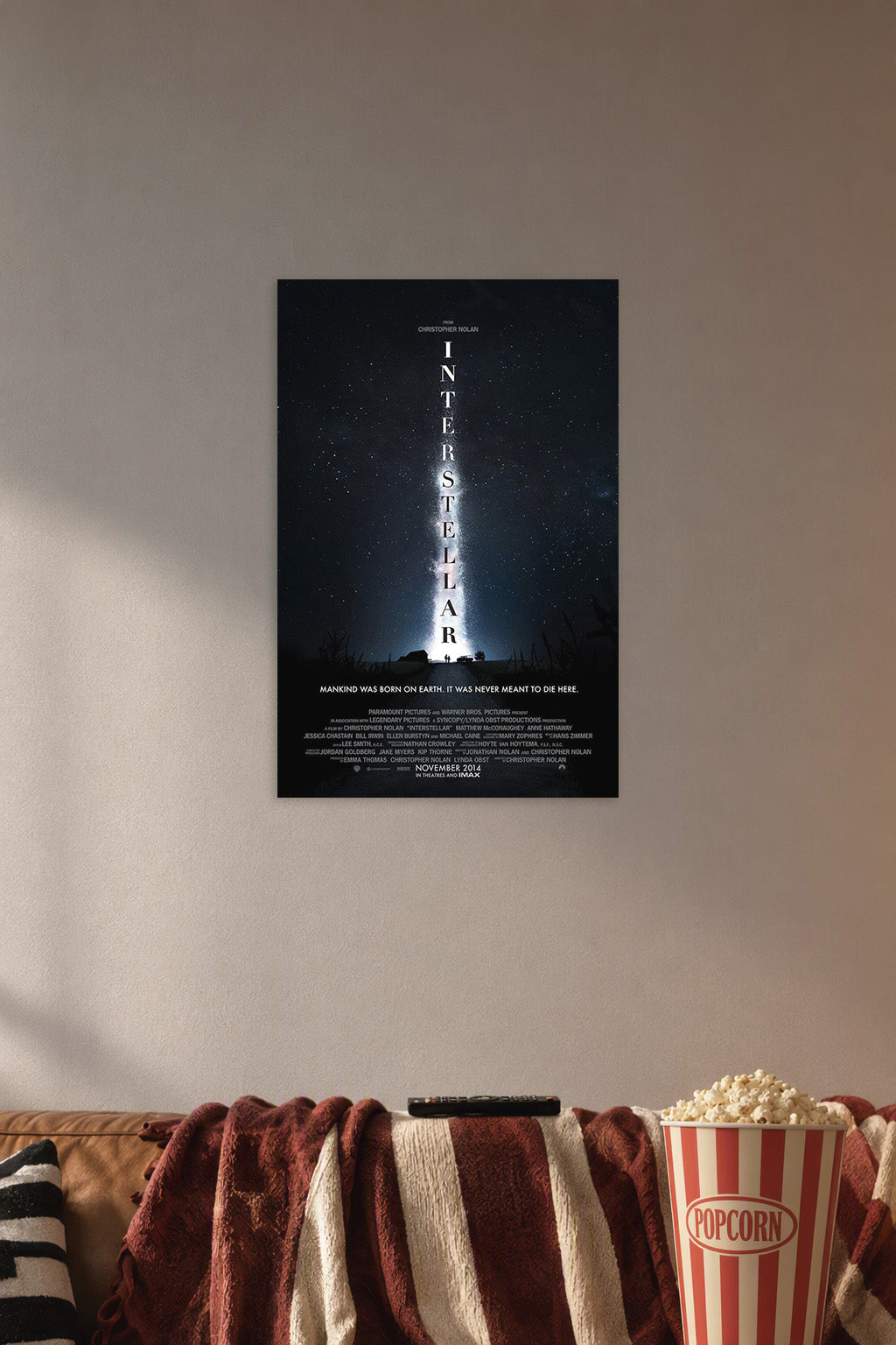 Interstellar Movie in a cozy movie room above a brown sofa with popcorn.