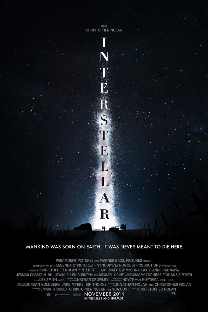 Interstellar poster features a star-filled midnight sky, glowing vertical title, and tiny figures by a house and vehicle.
