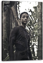 After Earth wall art print on a thick canvas, featuring Jaden Smith in a futuristic dark suit among dense green jungle foliage.