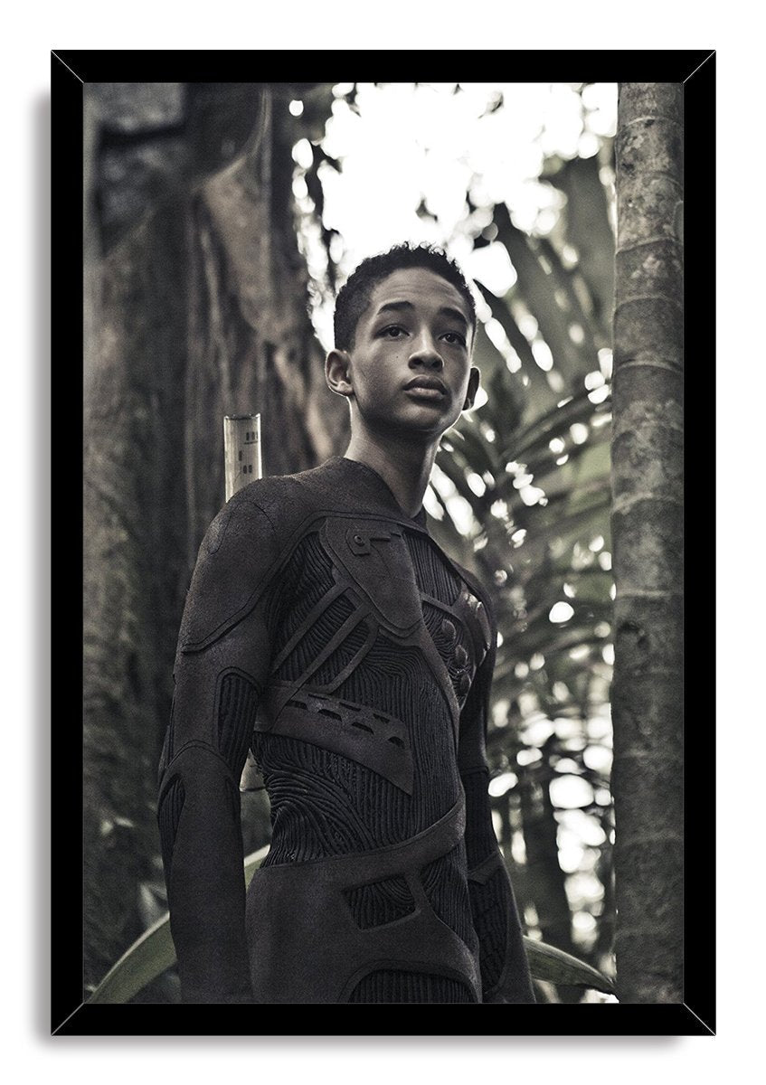 After Earth framed wall art print of Jaden Smith wearing an advanced dark bodysuit in a shadowy forest, set in a black frame.