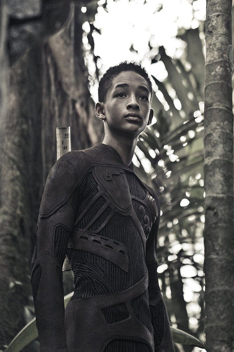 After Earth poster art of Jaden Smith as Cypher Raige in a dark textured survival suit amid tall jungle trees.