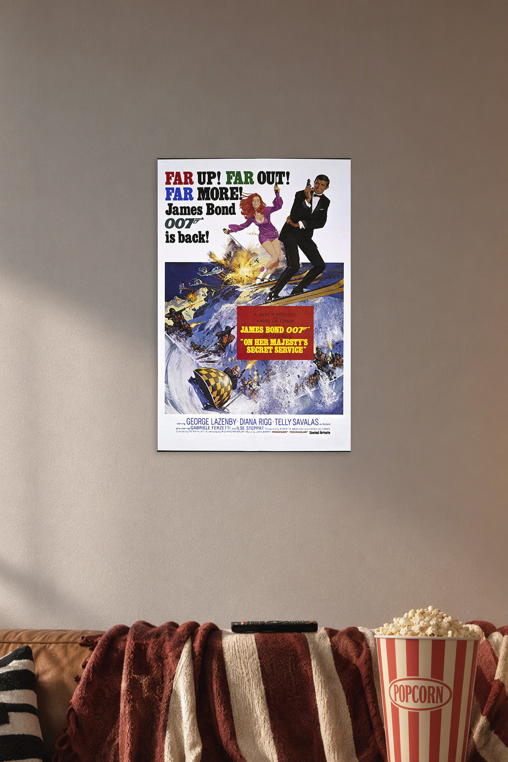 James Bond 007 On Her Majesty's Secret Service in a cozy movie room above a brown sofa with popcorn.