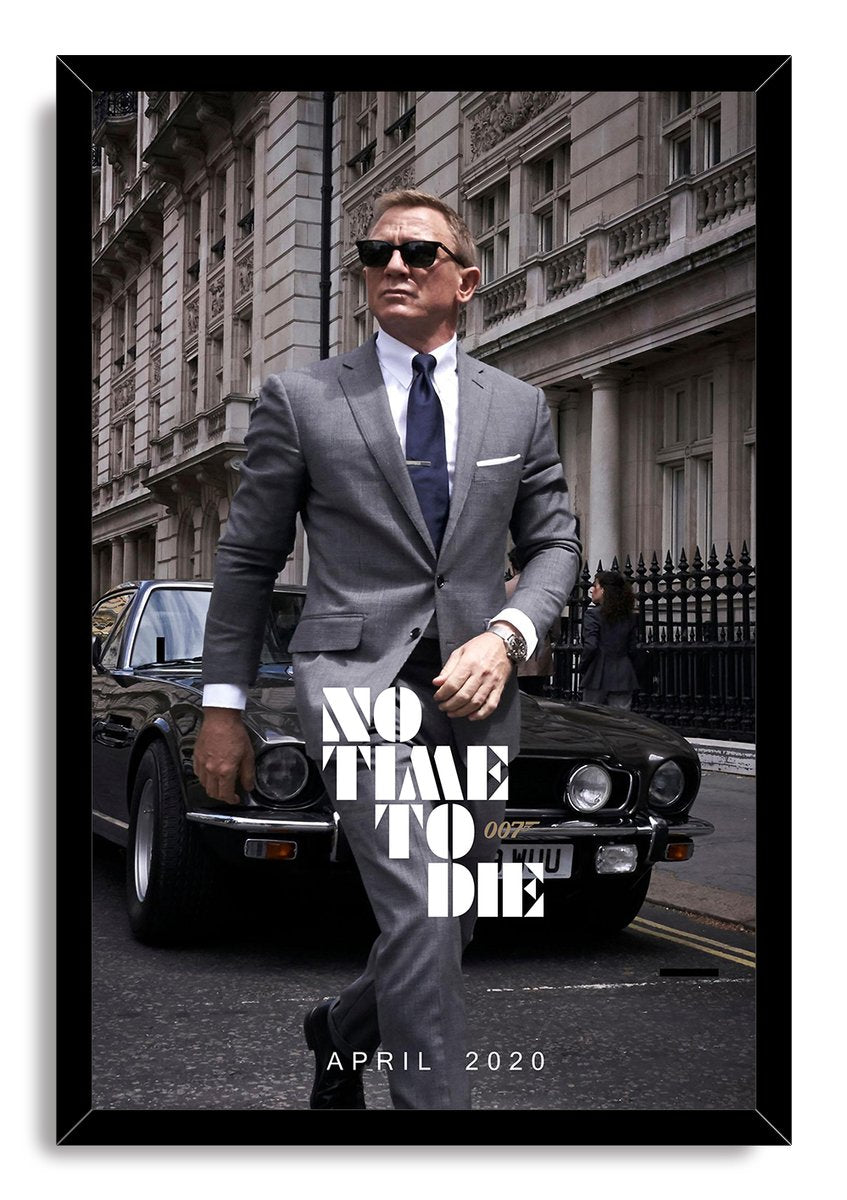 James Bond No Time To Die framed wall art print portrays Daniel Craig in sunglasses and a gray suit in front of a black sports car.