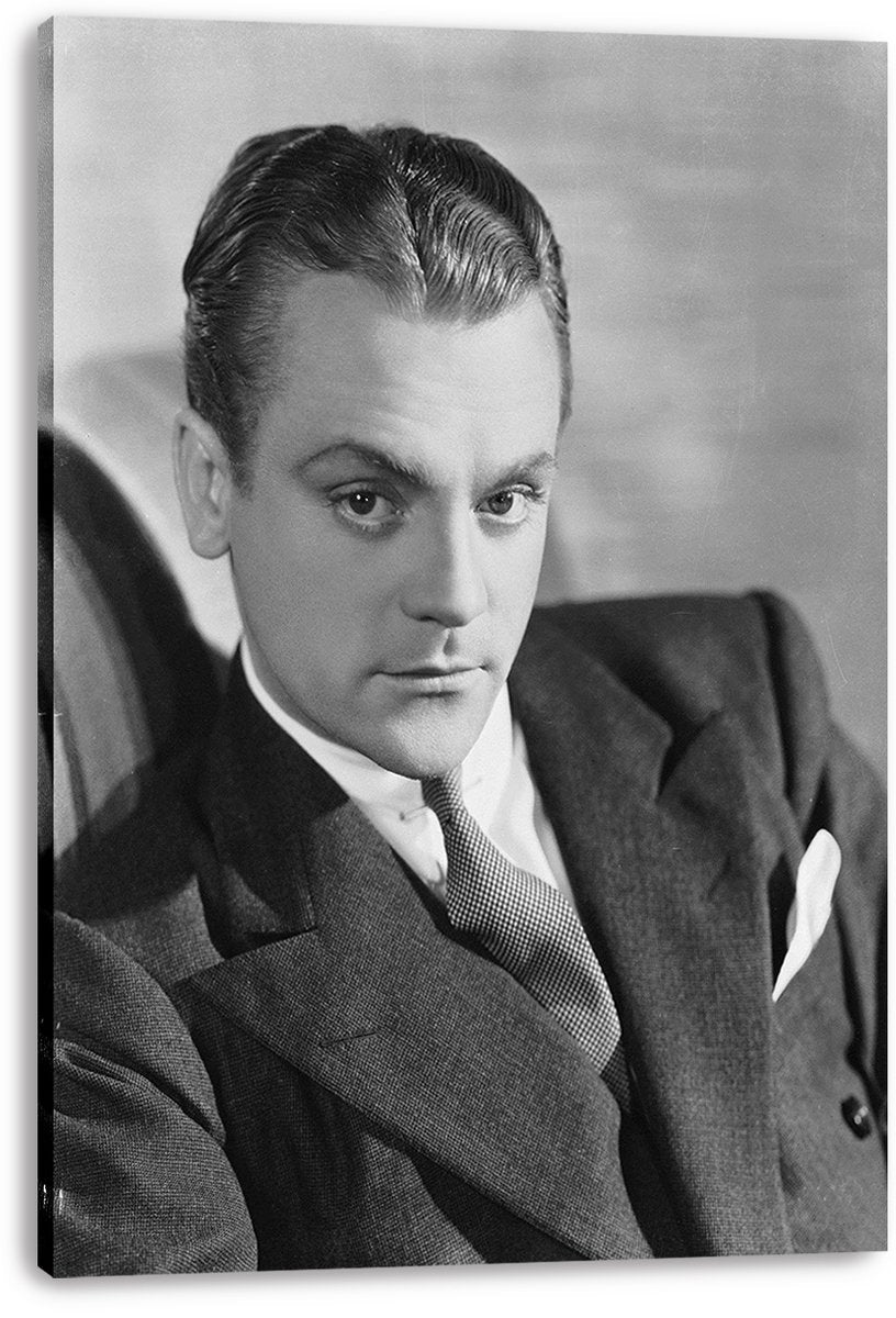 James Cagney canvas wall art print presents a monochrome portrait of the suited actor seated against a softly blurred backdrop.