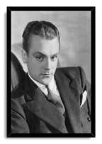 James Cagney framed wall art print displays a black-and-white portrait of the actor in a suit within a slim black frame.