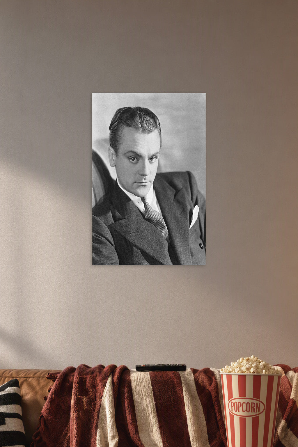 James Cagney in a cozy movie room above a brown sofa with popcorn.
