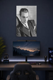 James Cagney in a gaming desk setup above a monitor.