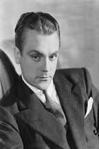 James Cagney wall art print features a black-and-white seated portrait of the actor in a dark suit, tie, and pocket square.