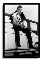 James Dean framed wall art print presents a black-and-white photo of the actor perched on a classic white car, bordered by a black frame.