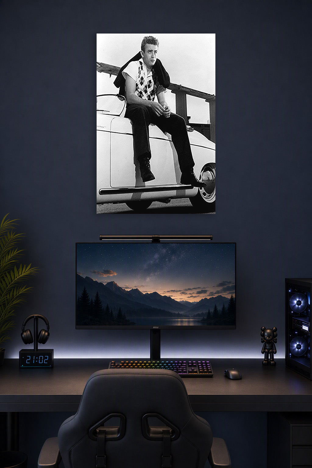 James Dean in a gaming desk setup above a monitor.