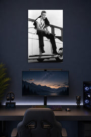James Dean in a gaming desk setup above a monitor.