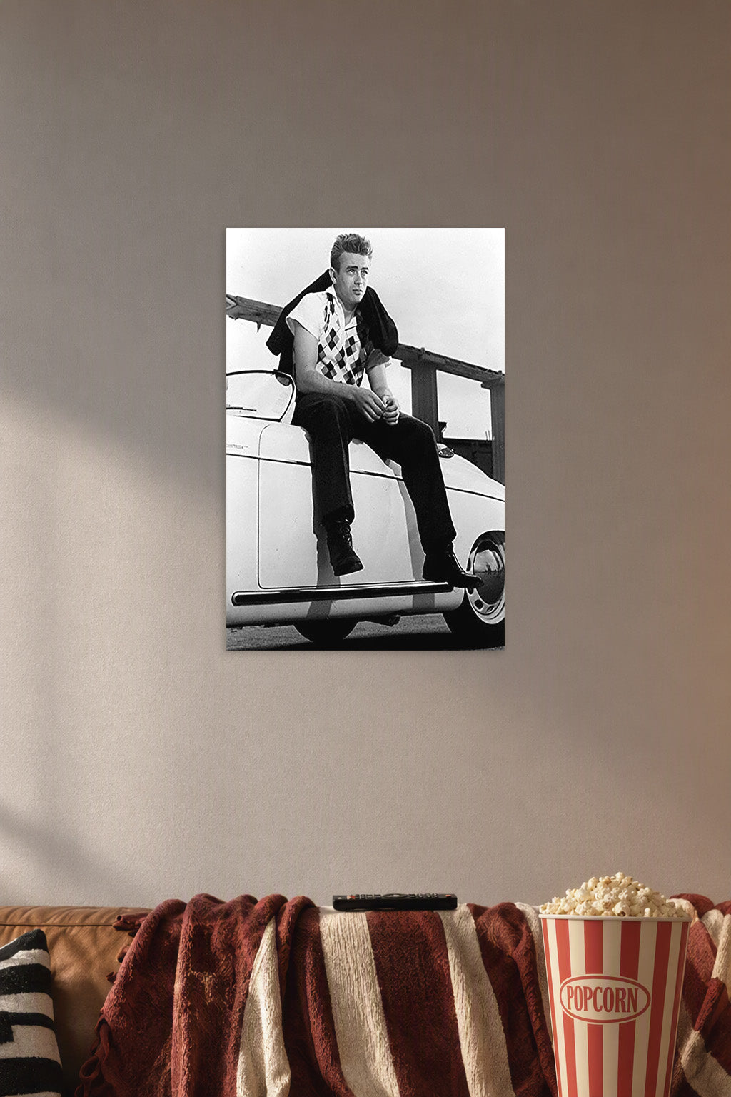 James Dean in a cozy movie room above a brown sofa with popcorn.