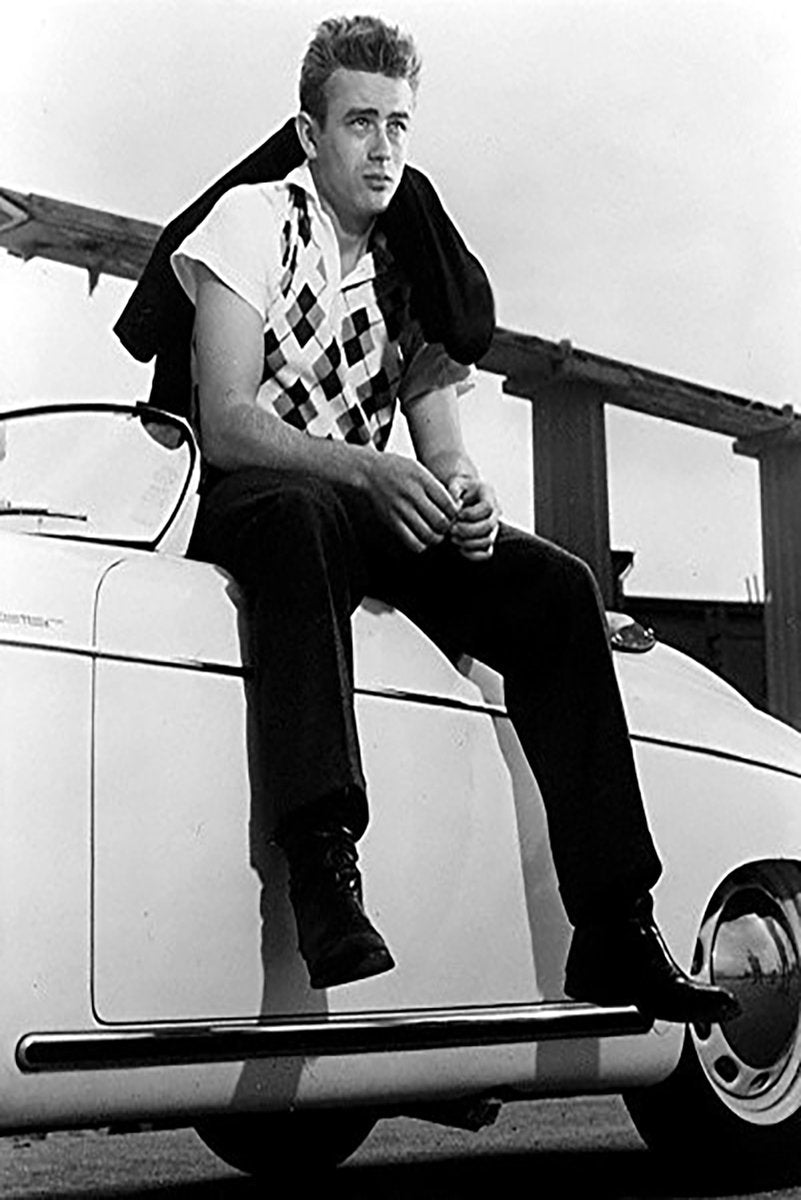James Dean poster features a black-and-white portrait of the actor seated on a white classic car with a jacket over his shoulder.
