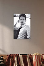 James Franco in a cozy movie room above a brown sofa with popcorn.