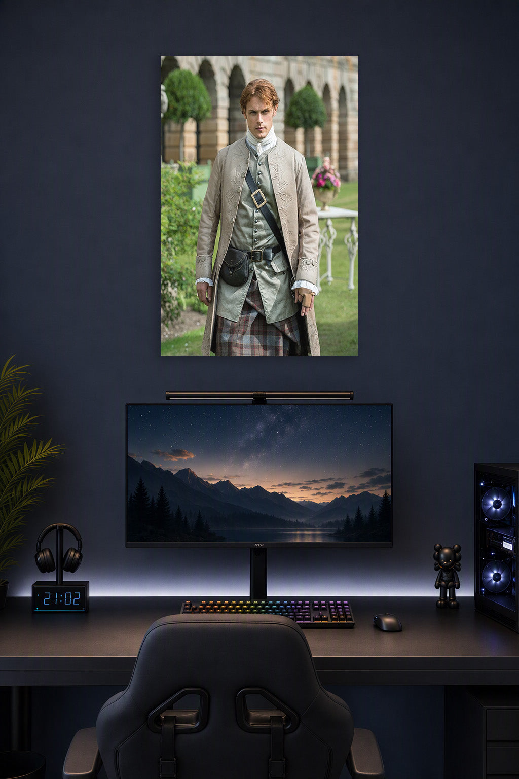 Jamie Fraser Outlander in a gaming desk setup above a monitor.
