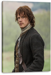 Jamie Fraser canvas wall art print displays Sam Heughan in period clothing, gazing over his shoulder before a muted green and blue outdoor background.