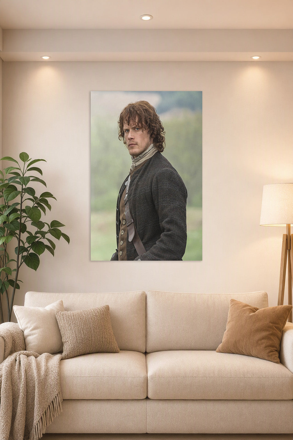 Jamie Fraser (Sam Heughan) from Outlander in a bright living room above a beige sofa.