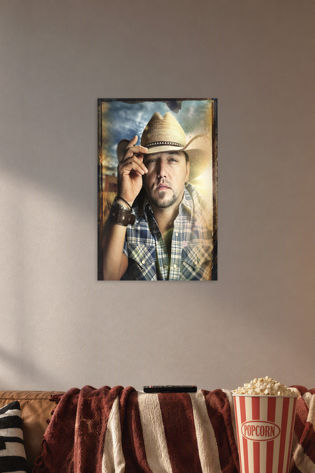 Jason Aldean in a cozy movie room above a brown sofa with popcorn.