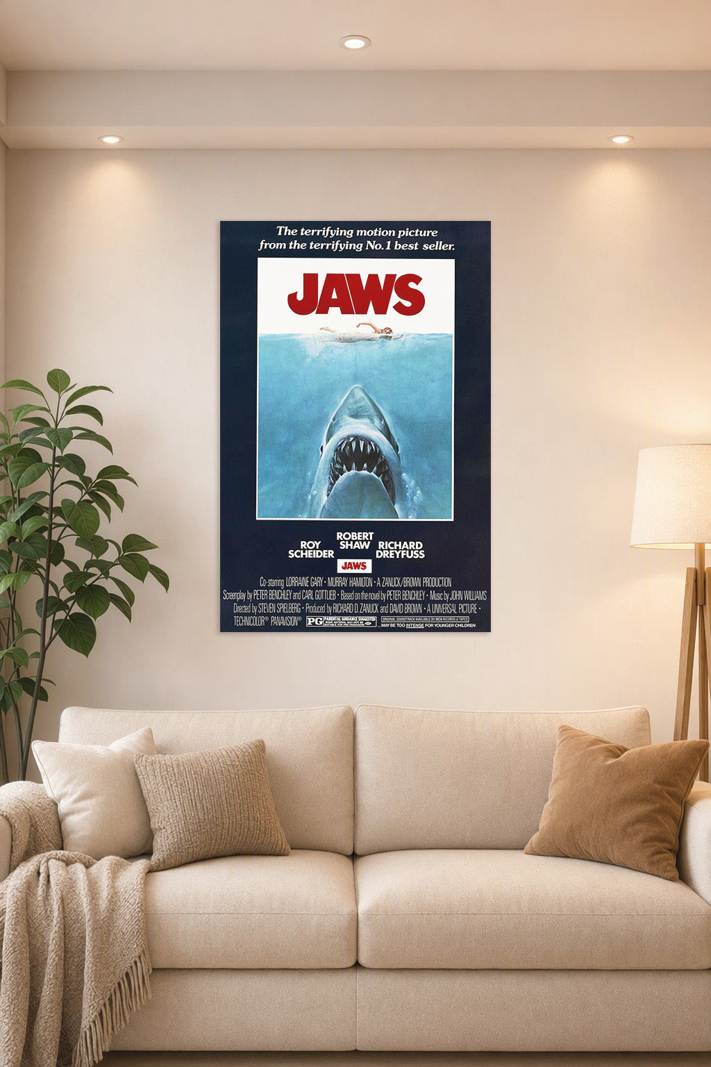 Jaws Movie Poster in a bright living room above a beige sofa.
